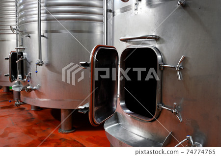 Industrial stainless steel vats in modern brewery. Industrial stainless steel vats in modern brewery. 74774765