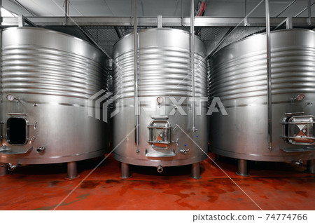 Industrial stainless steel vats in modern brewery. Industrial stainless steel vats in modern brewery. 74774766