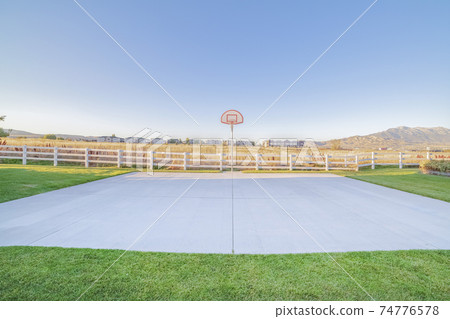 Outdoor basketball court with goalpost on a sunny day Outdoor basketball court with goalpost on a sunny day 74776578