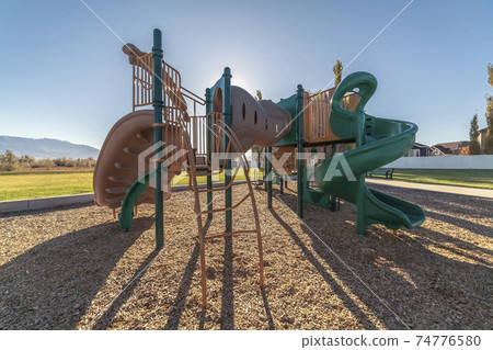 Colorful twisted slides in a kids playground Colorful twisted slides in a kids playground 74776580