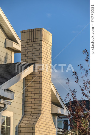 Feature brick chimney on a house exterior Feature brick chimney on a house exterior 74776581