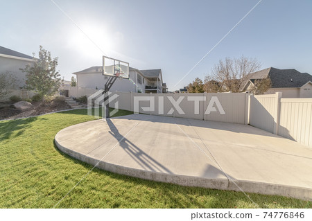 Small all weather practice basketball court on a sunny day 74776846