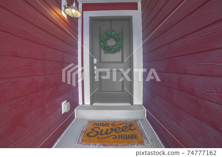 Entrance door with Home Sweet Home mat Entrance door with Home Sweet Home mat 74777162