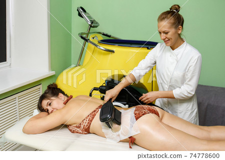 Woman getting cryolipolysis fat treatment in beauty salon Woman getting cryolipolysis fat treatment in beauty salon 74778600