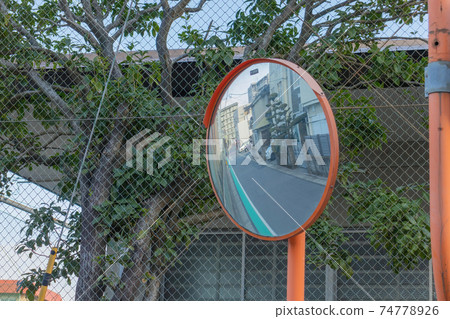 Safety mirror provides a view into the adjacent street. 74778926
