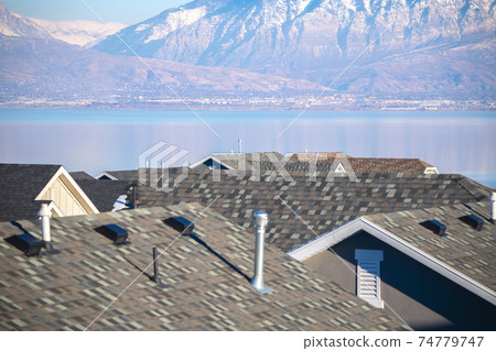 Roofs of residential houses against Utah Lake 74779747