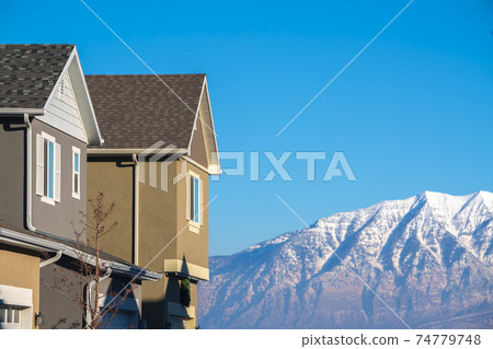 View of houses against mountains on sunny day 74779748