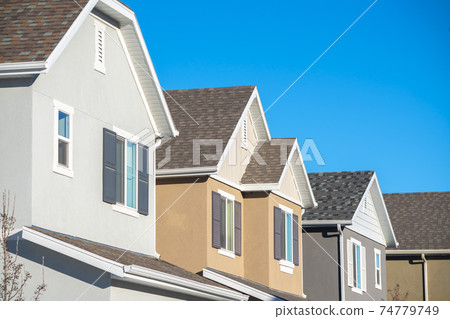 Row of upper floor house facades with shutters 74779749
