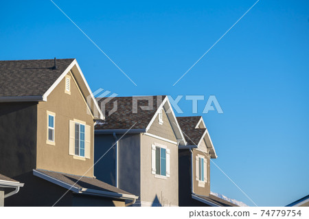 American house facades against blue sky day light 74779754