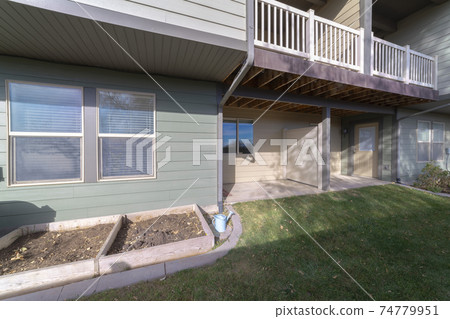 Small back yard with lawn and raised flowerbeds 74779951