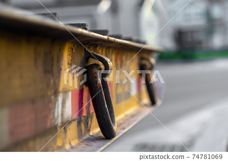 Platform with rusty metal rings on the side and raised bands at the surface Platform with rusty metal rings on the side and raised bands at the surface 74781069