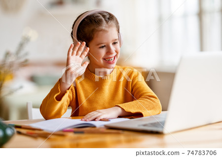 Happy girl greeting teacher during online lesson at home Happy girl greeting teacher during online lesson at home 74783706