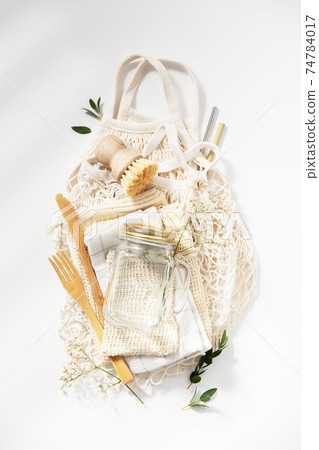 Zero waste, eco friendly concept. Glass jars, mesh bags, natural brush and bamboo cutlery on white background 74784017