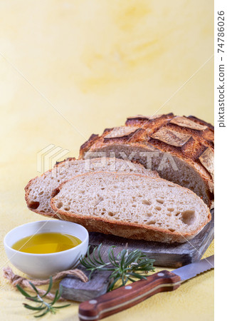 Freshly baked artisanal bread and olive oil. 74786026