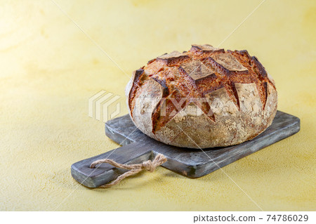 Freshly baked artisanal bread. 74786029
