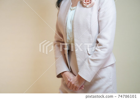 woman with hands on lower abdomen woman with hands on lower abdomen 74786101