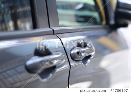 Driver's door of a passenger car parked in parking 74786197