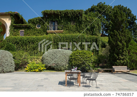 patio seat and table near climber spring house 74786857