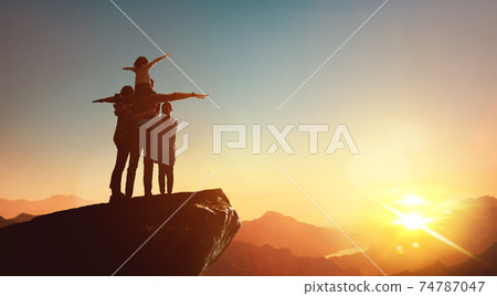 Happy family at sunset. 74787047