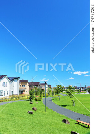 A residential area and a park in blue sky 74787268