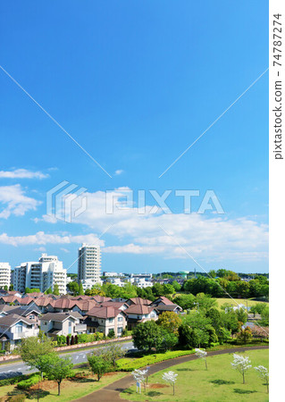 A residential area and a park in blue sky A residential area and a park in blue sky 74787274