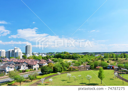 A residential area and a park in blue sky A residential area and a park in blue sky 74787275