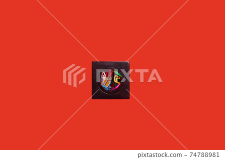 paper clips in a box on a red surface 74788981