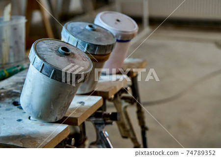 Painting chamber, spray gun. Furniture manufacture. Close-up Painting chamber, spray gun. Furniture manufacture. Close-up 74789352