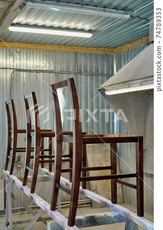 Stool frame of dark wood timber in painting booth Stool frame of dark wood timber in painting booth 74789353