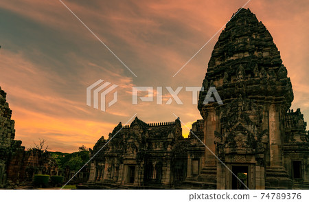 Landscape of Phimai Historical Park with sunset sky. Landmark of Nakhon Ratchasima, Thailand. Travel destinations. Historic site is ancient. Ancient building. Khmer temple classical architecture. 74789376