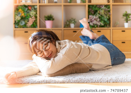 Young woman singing in the living room Young woman singing in the living room 74789437