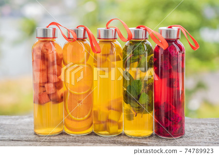Cambucha with various fruits arranged in the form of a rainbow. Homemade fermented raw kombucha tea with different flavorings. Healthy natural probiotic flavored drink. LGBT Cambucha with various fruits arranged in the form of a rainbow. Homemade fermented raw kombucha tea with different flavorings. Healthy natural probiotic flavored drink. LGBT 74789923