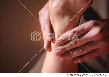 Close-up massage of legs and feet of a client in a massage parlor Close-up massage of legs and feet of a client in a massage parlor 74792247