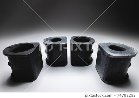 Set of new rubber bush for car suspension anti-roll bar on gradient gray background 74792282