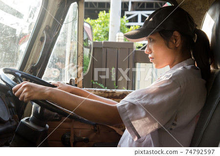 young woman driving a truck young woman driving a truck 74792597