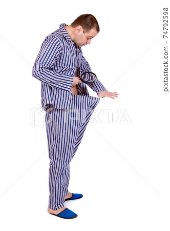 Man looking in his underwear Man looking in his underwear 74792598