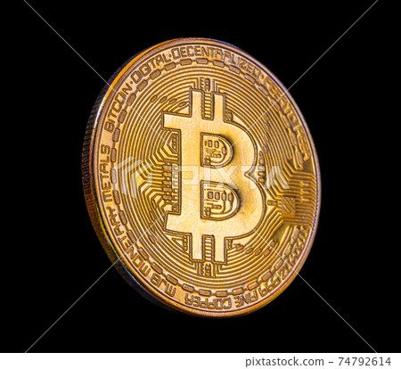 A one golden bitcoin coin on a black background. A one golden bitcoin coin on a black background. 74792614
