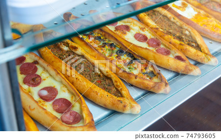 Traditional Turkish pide with various fillings on bakery showcase Traditional Turkish pide with various fillings on bakery showcase 74793605