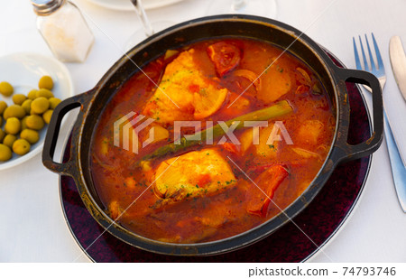 Baked merluse with vegetables and tomato sauce 74793746