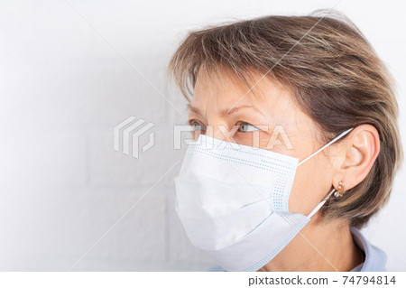 Elderly caucasian woman wearing medical face mask. Elderly caucasian woman wearing medical face mask. 74794814