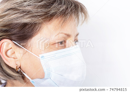 Elderly caucasian woman wearing medical face mask.  74794815