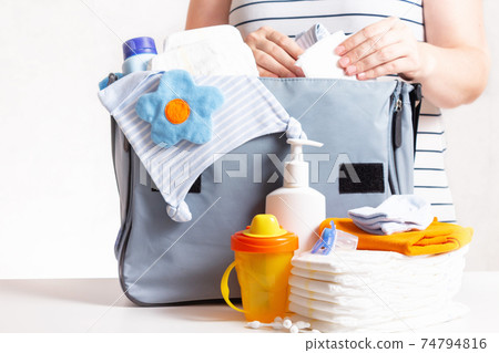 Woman packing diaper bag in maternity hospital. 74794816