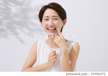 Middle female dental care with a toothbrush 74795475