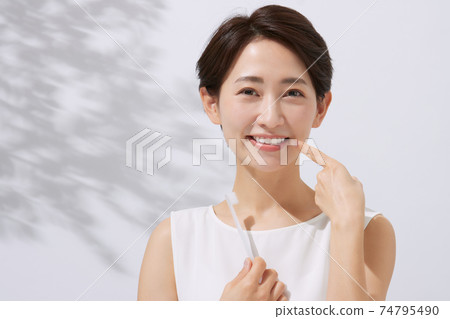 Middle female dental care with a toothbrush 74795490