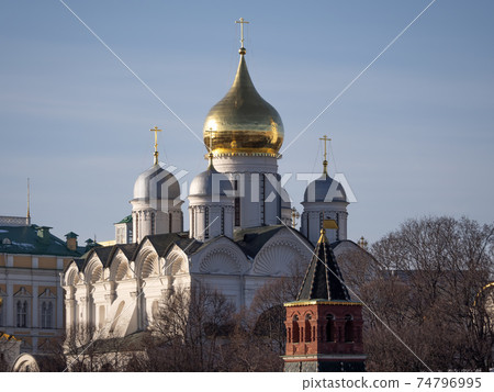 Golden dome with orthodox cross close-up on a blue sky background Golden dome with orthodox cross close-up on a blue sky background 74796995