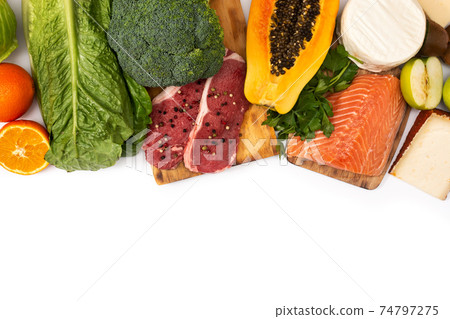 Vitamin A in food isolated on white background. Top view. Copy space 74797275