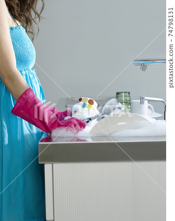 Woman In Blue Dress And Gloves Washing Dishes Woman In Blue Dress And Gloves Washing Dishes 74798131