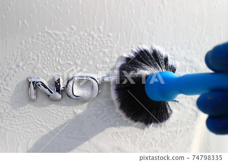 Detailed cleaning of the emblem with a detailing brush 74798335