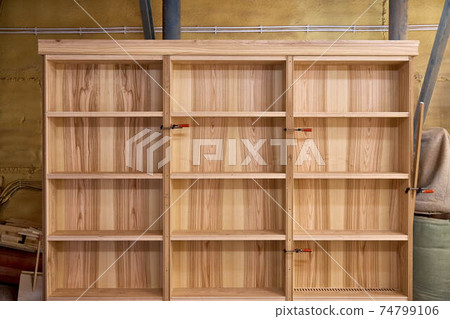 Ash veneered mdf bookcase in workshop. Wooden furniture Ash veneered mdf bookcase in workshop. Wooden furniture 74799106