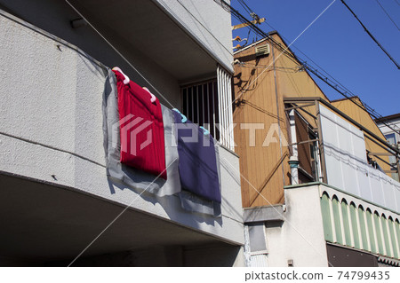 Dry the futon on the balcony of the apartment 74799435